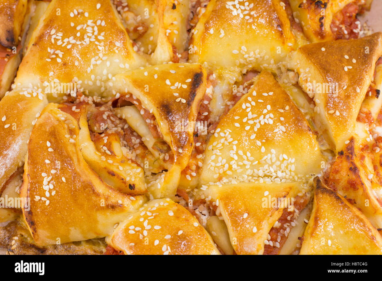 homamade triangle shaped pizza pastry close up Stock Photo