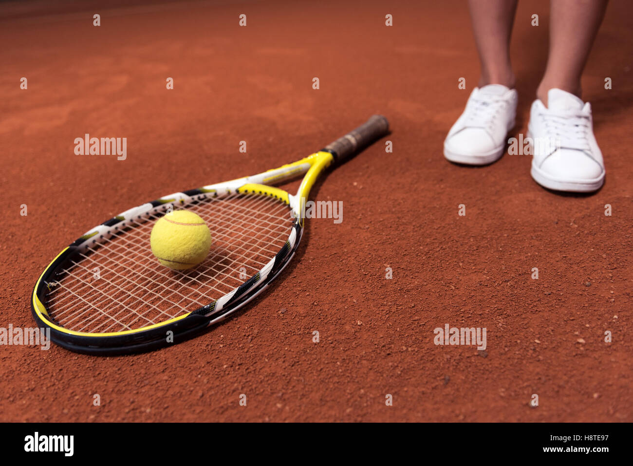 Tennis racket and ball lying on the surface of court Stock Photo Alamy