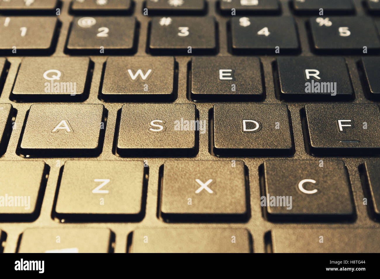 Left side of island styled laptops keyboard. Shot in closed distance with single lighting technique. Stock Photo