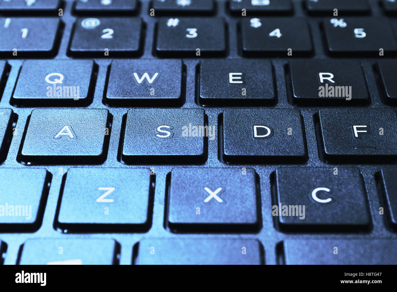 Left side of island styled laptops keyboard. Shot in closed distance with single lighting technique. Stock Photo