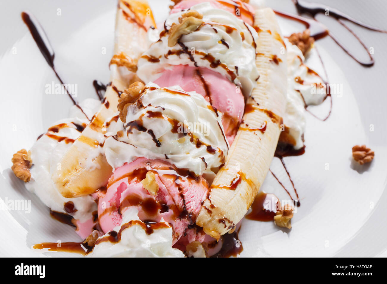 Banana split ice cream with whipped , nuts and cherry Stock Photo Alamy