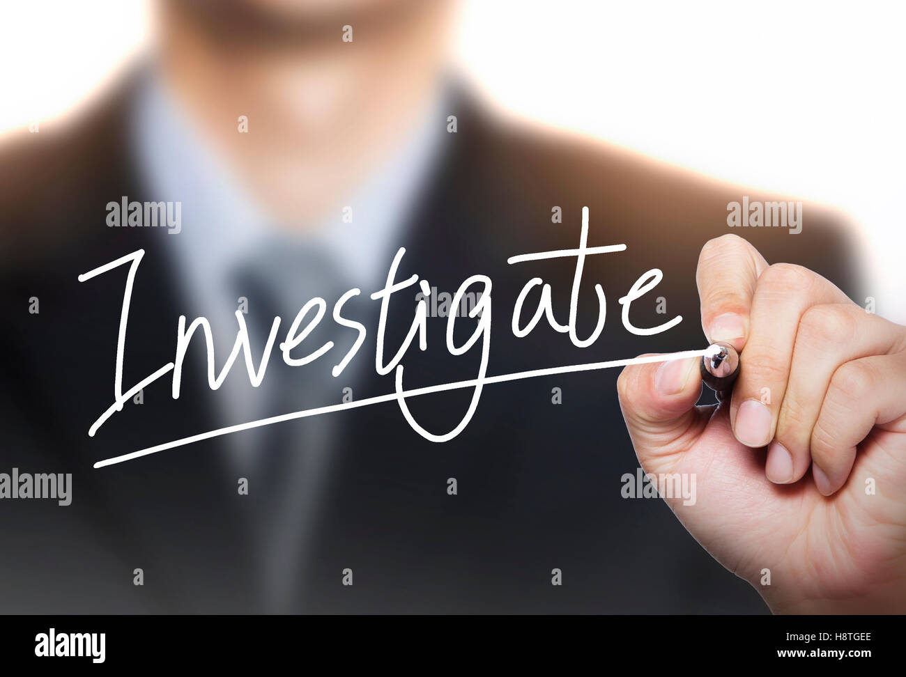 investigate written by hand, hand writing on transparent board, photo Stock Photo