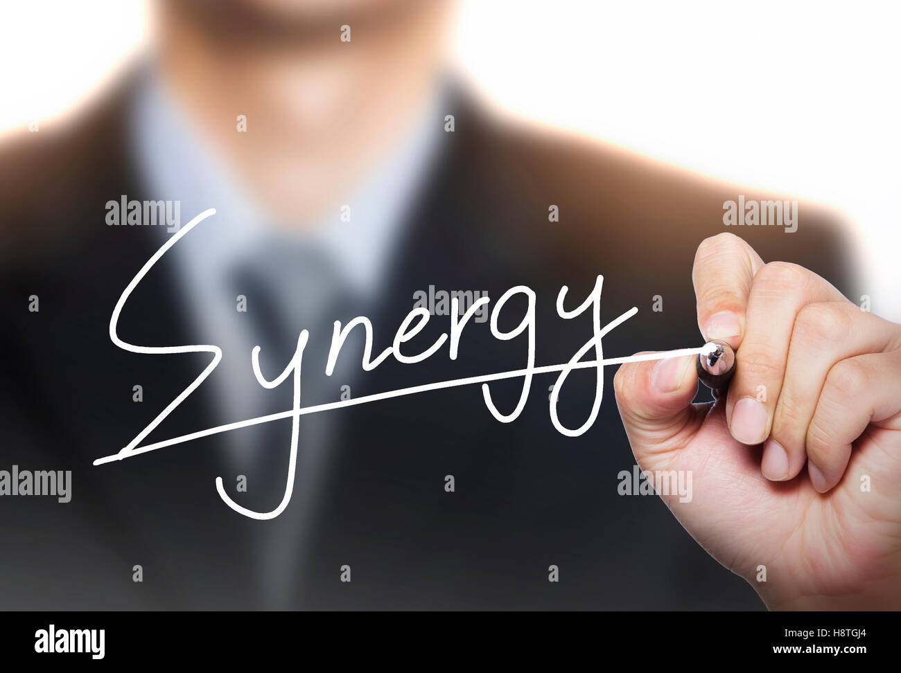 synergy written by hand, hand writing on transparent board, photo Stock Photo