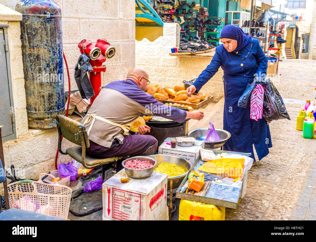 The woman buying falafel  - traditional street food in Palestine Stock Photo