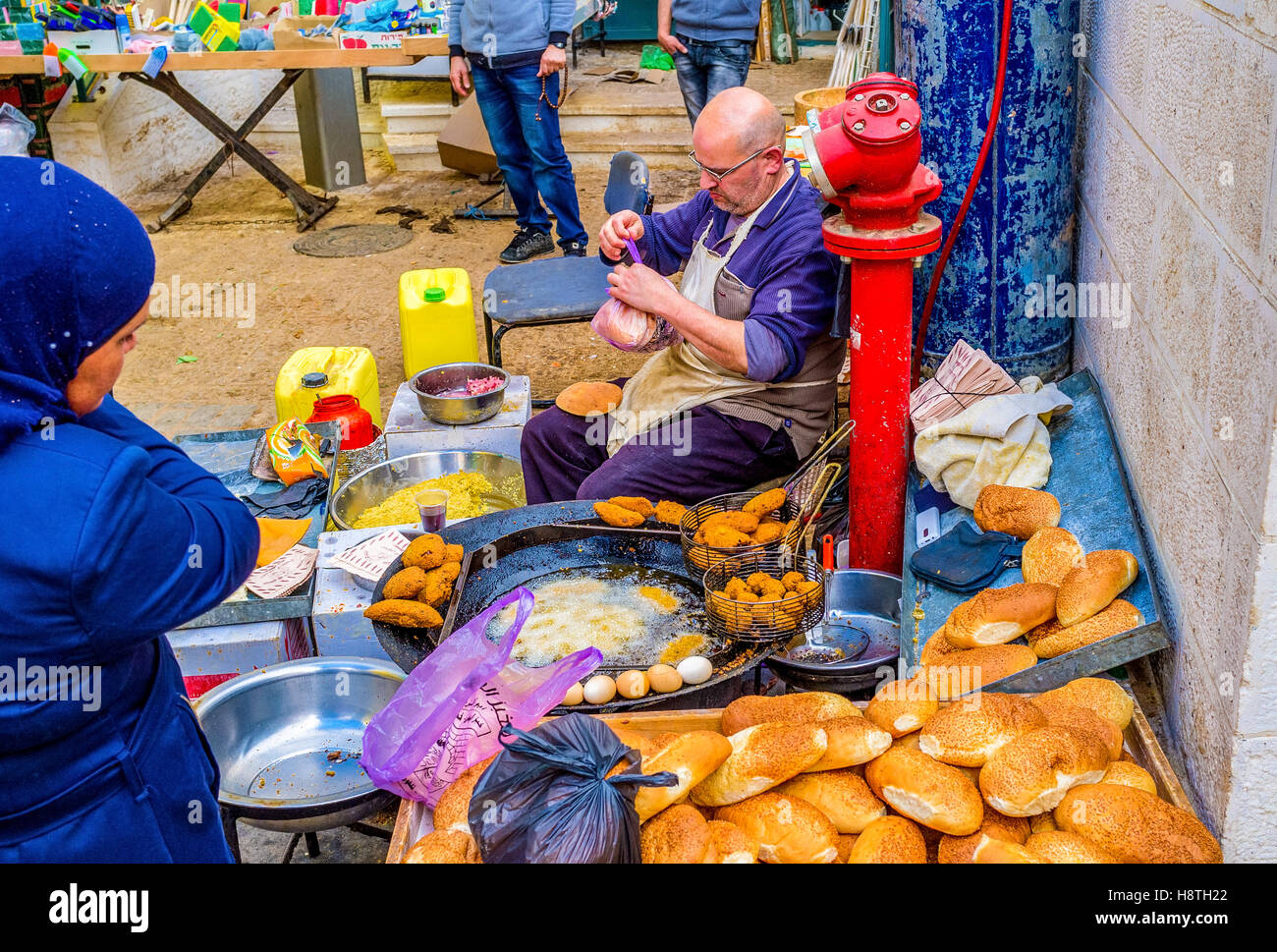 The outdoor cook prepares the falafel on frying pan in the Bethlehem market Stock Photo