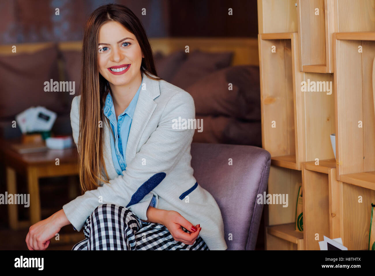 Beautiful Young Woman Sitting in Coffee Shop and Smiling Stock Photo ...