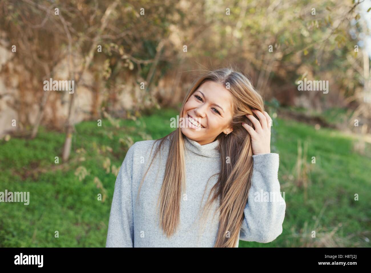 Nice portrait of blonde girl with green grass of background Stock Photo ...