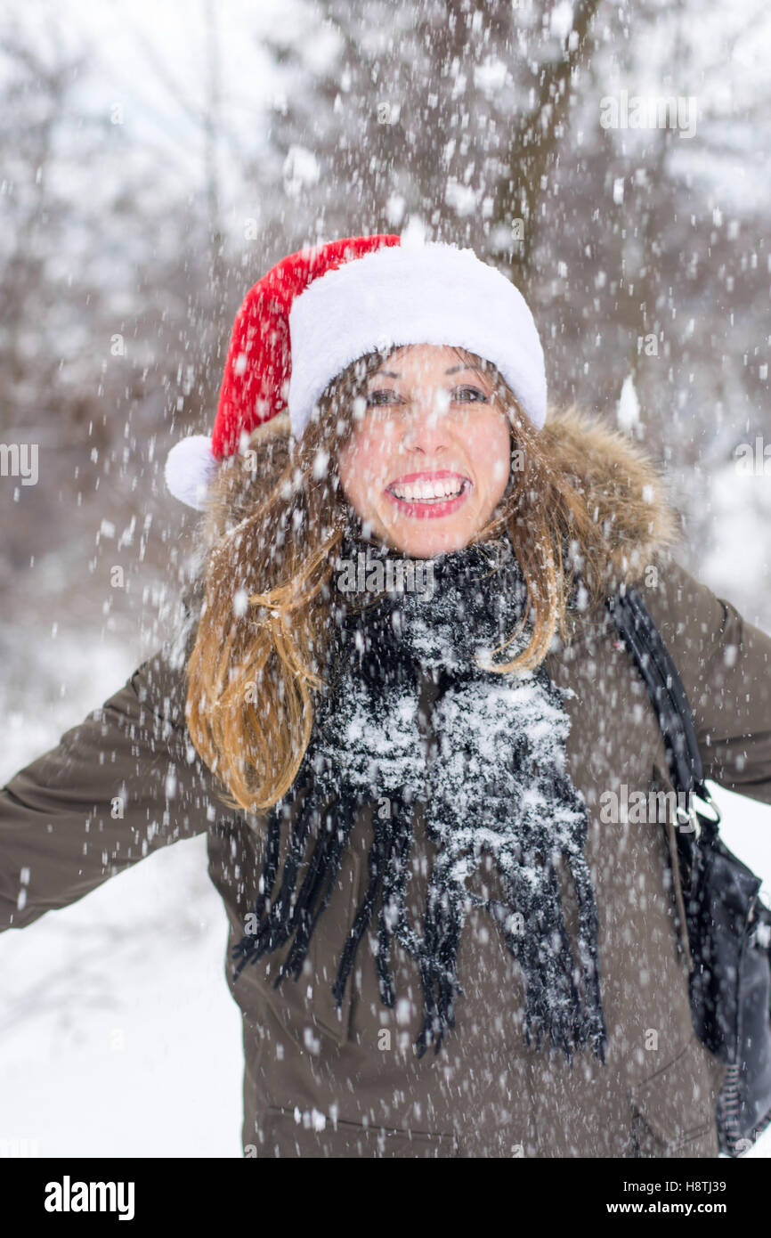 Woman enjoying winter day in snow covered park Stock Photo