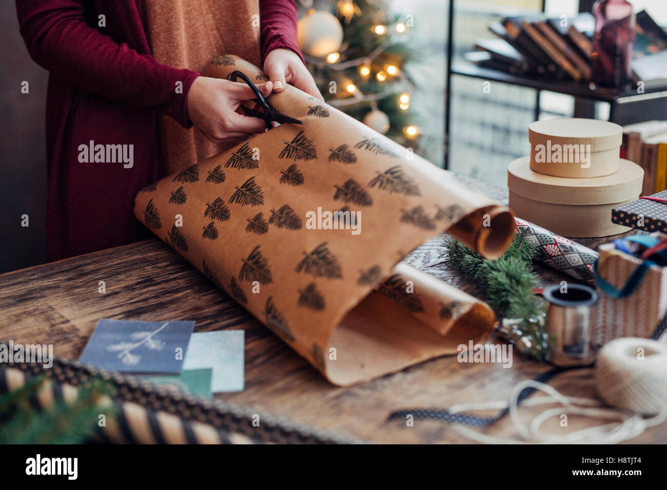 Woman Wrapping and Decorating Christmas Present Stock Photo Alamy