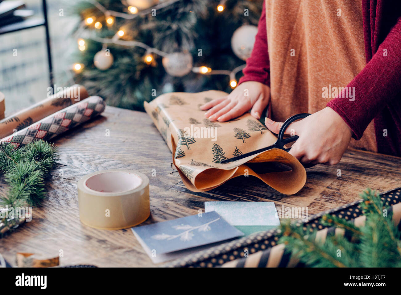 Woman Wrapping and Decorating Christmas Present Stock Photo Alamy