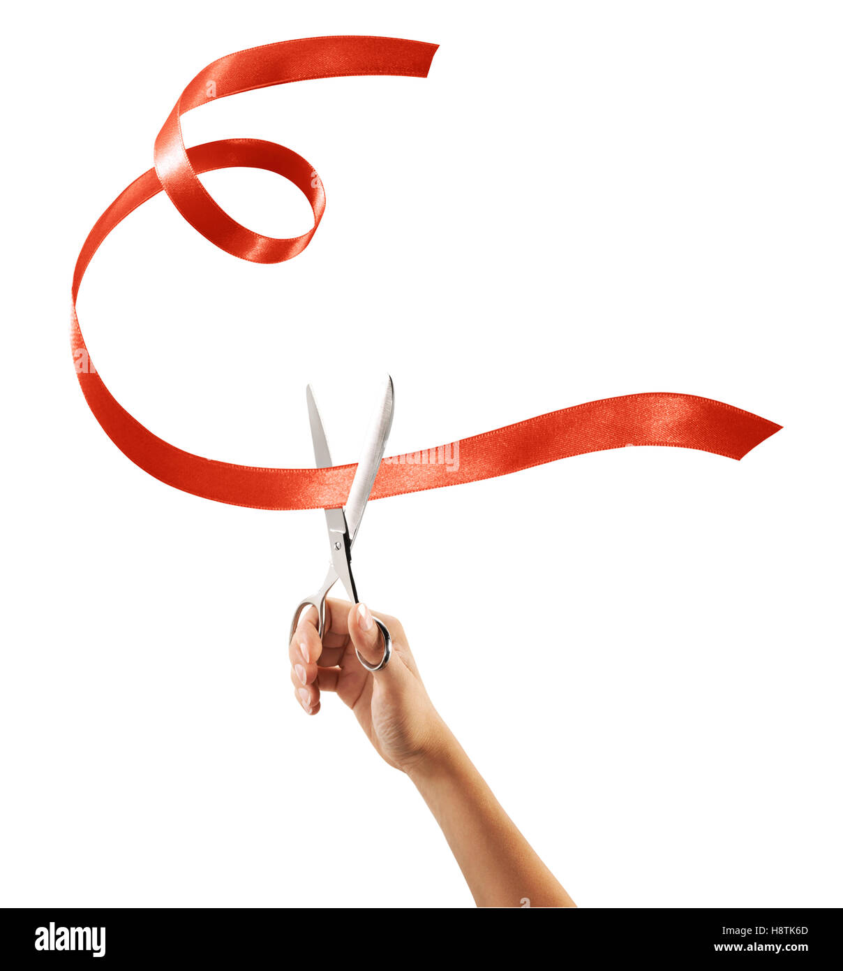 Scissors cutting through red ribbon or tape, isolated on white. Stock Photo