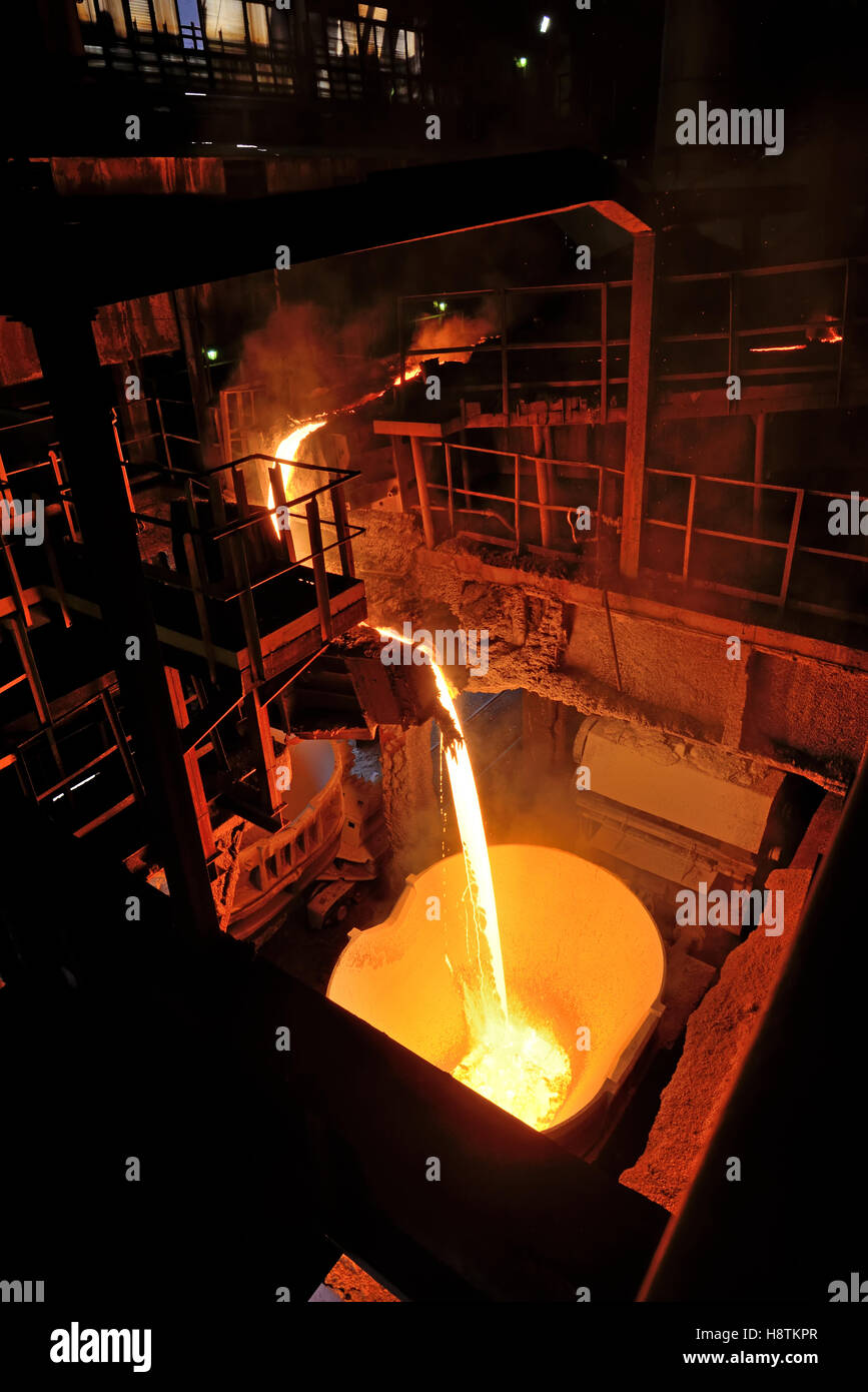 pouring molten steel in steel ladle Stock Photo