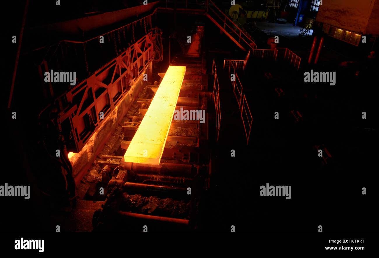 Sheet of hot metal on the conveyor belt from oven Stock Photo