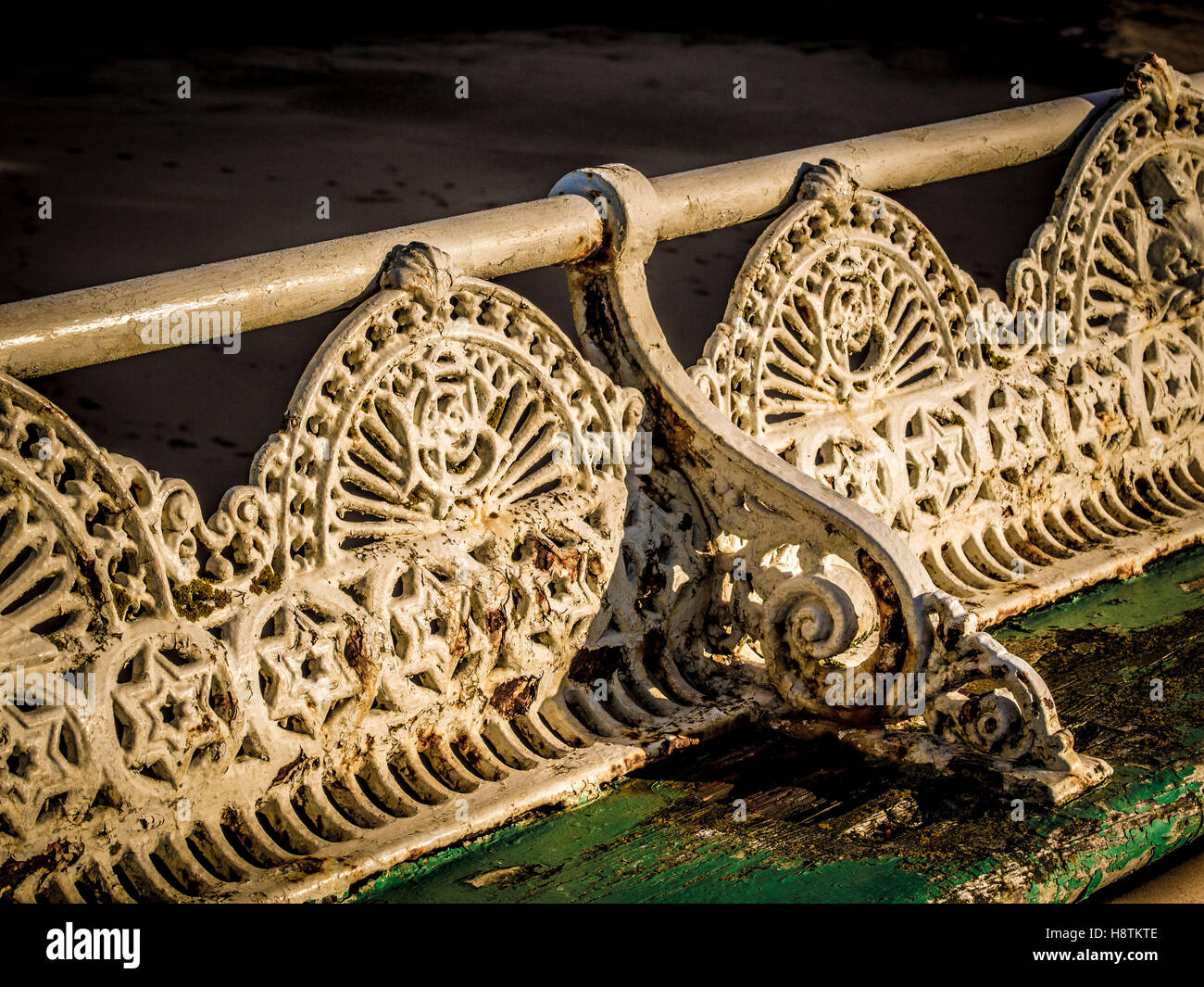 Traditional cast iron seats in a state of disrepair on Pier, Blackpool, Lancashire, UK. Stock Photo
