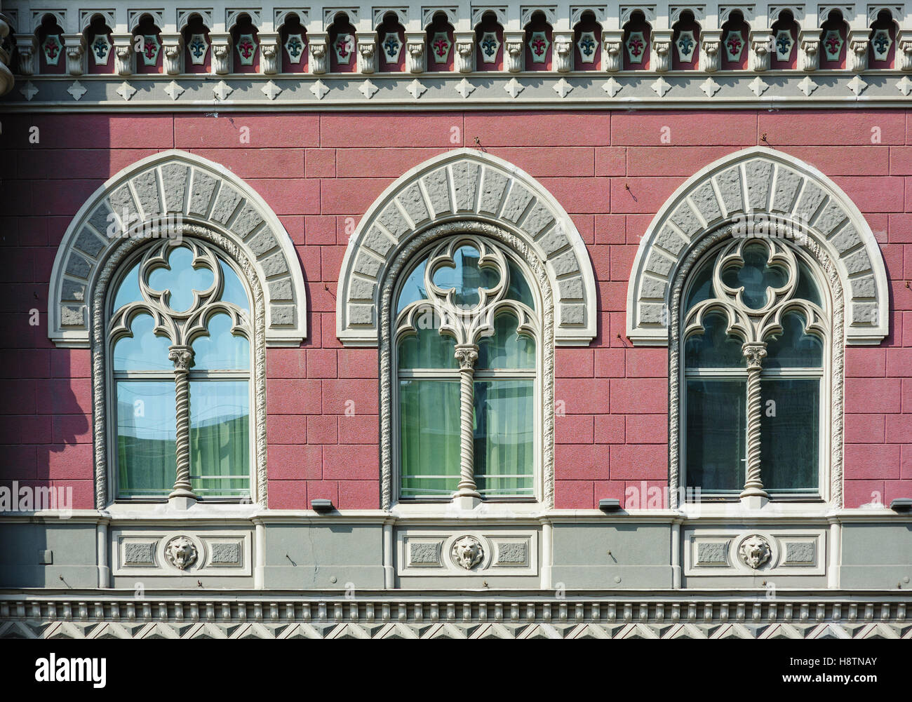 three Windows with arches in old architectural building Stock Photo
