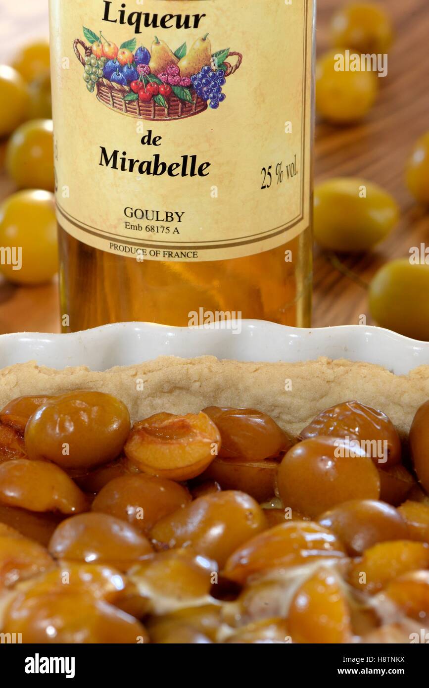 liquor bottle and pie Mirabelle plum (Prunus domestica syriaca ...
