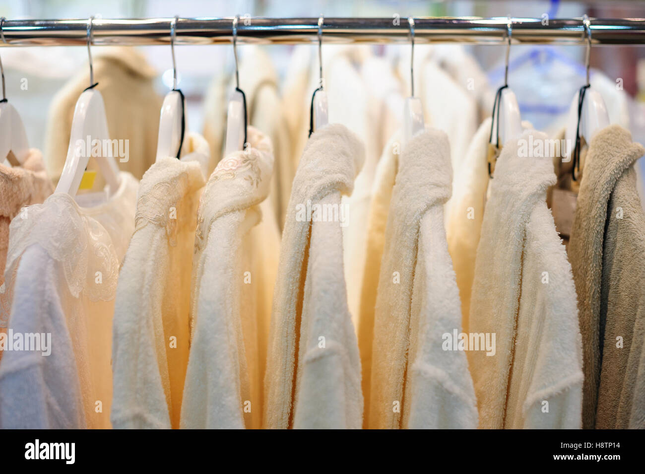 white man shirts on hangers in store Stock Photo