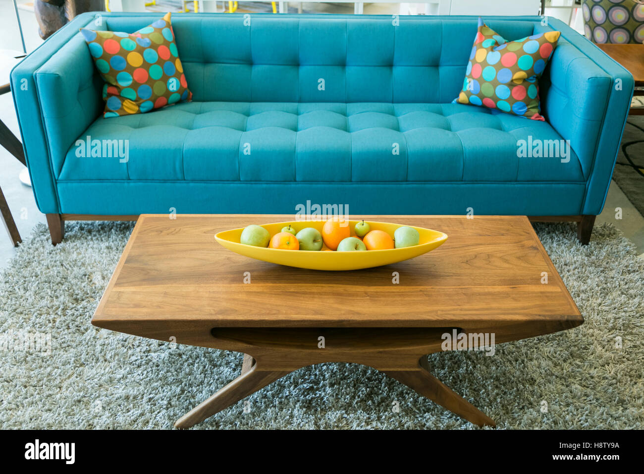 Mid Century blue sofa and wooden coffee table in Palm Springs, California, USA. Stock Photo