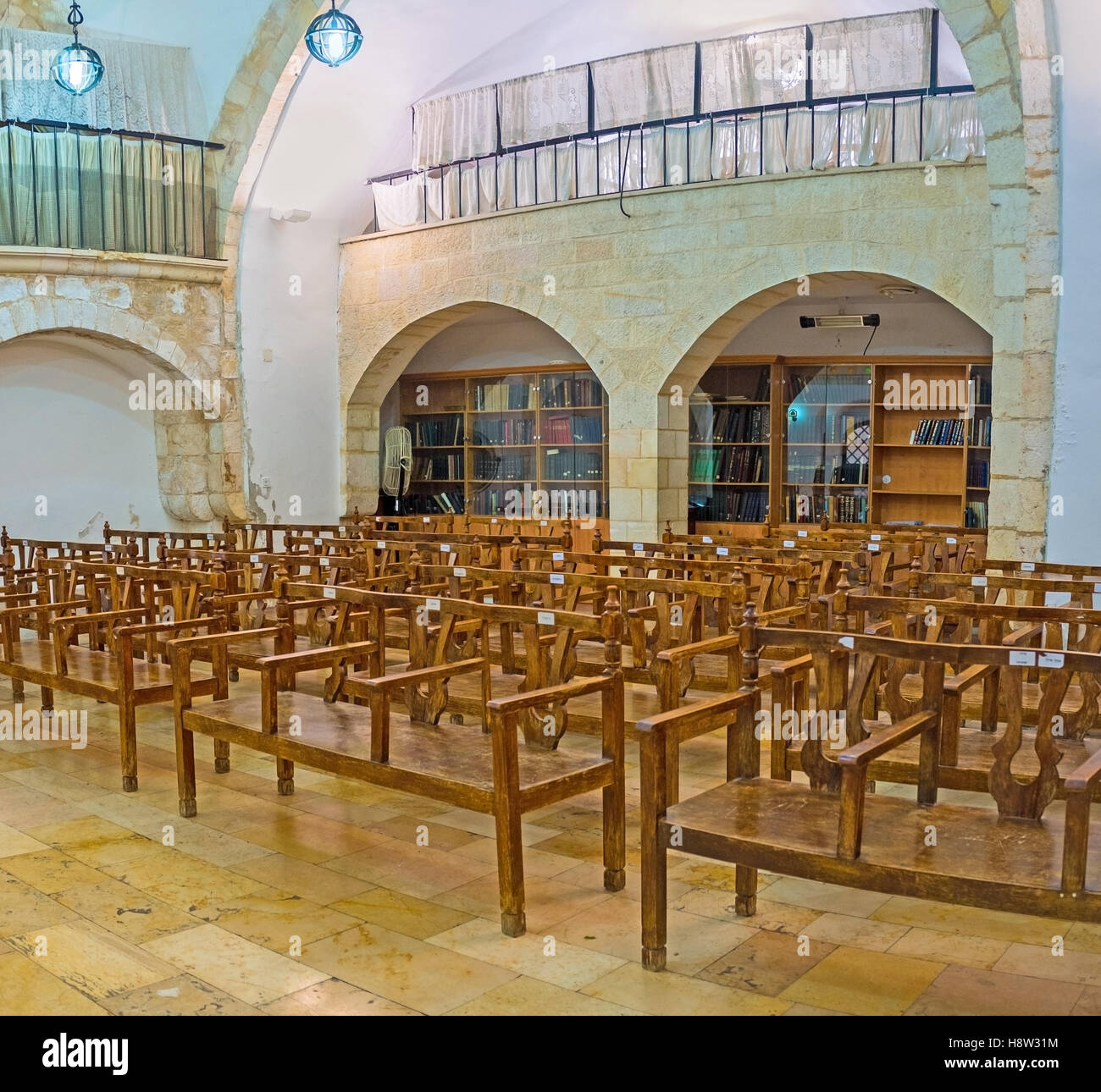 The interior of Eliyahu Hanavi synagogue with the book shelves on the background Stock Photo
