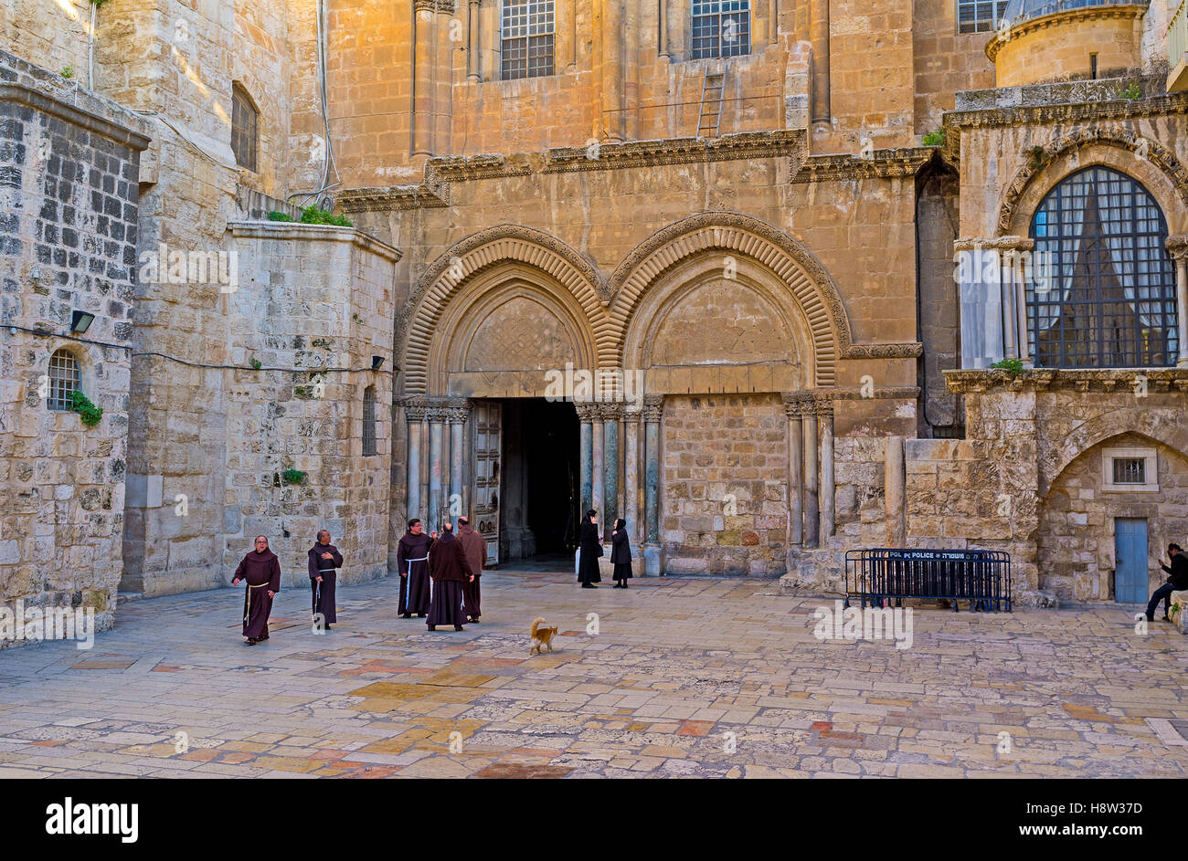 The courtyard of the Church of the Holy Sepulchre with the Franciscan monks, going after the worship Stock Photo