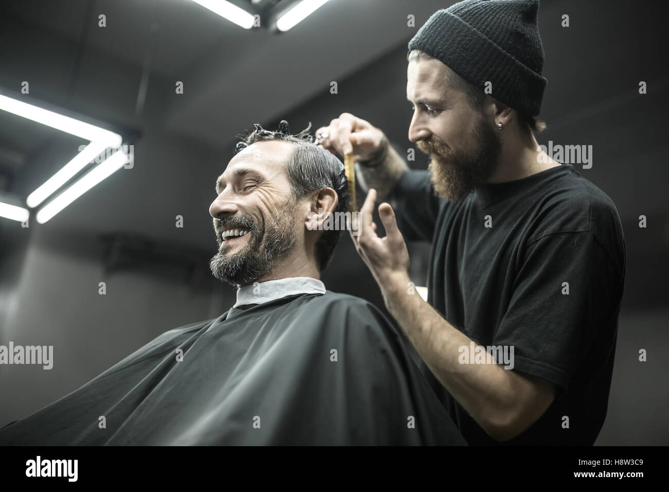 Cutting hair in barbershop Stock Photo - Alamy