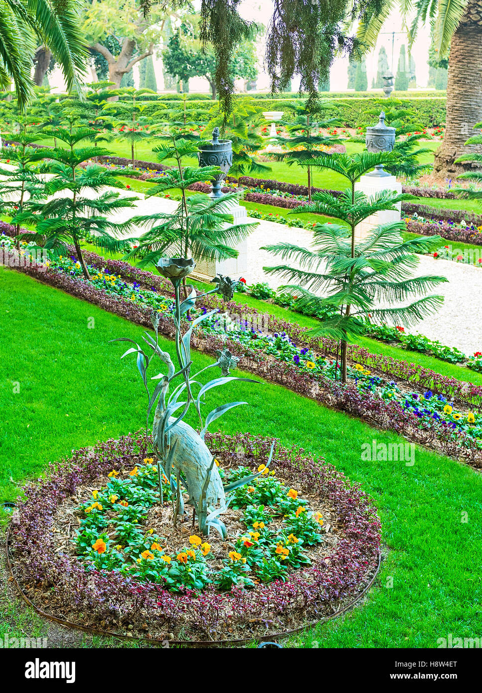 The park sculpture of the heron in the reeds, located in glower bed in Bahai Garden, Haifa, Israel. Stock Photo