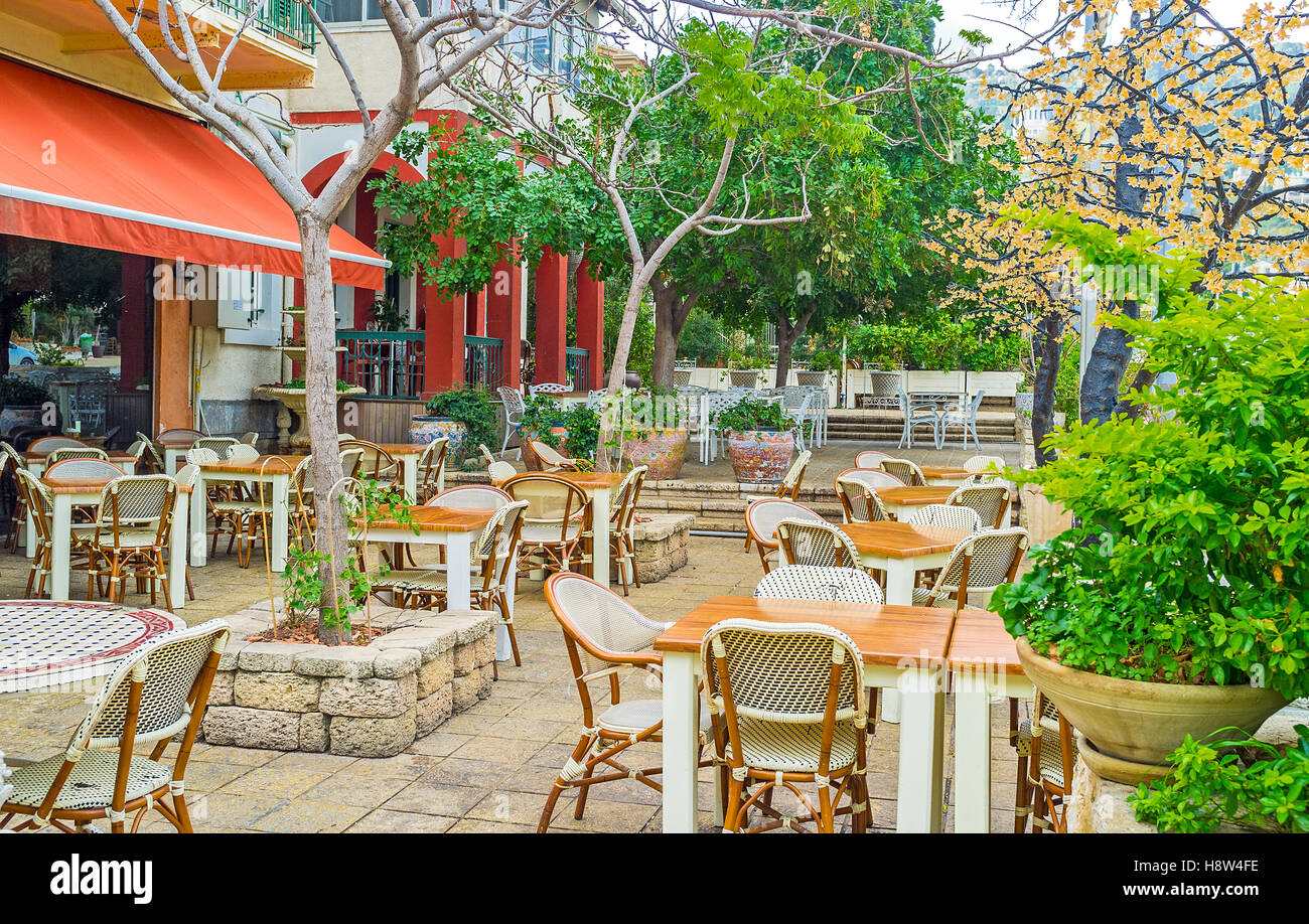 The cafes and taverns in German Colony have nice and cozy summer terraces, decorated with plants, Haifa, Israel. Stock Photo