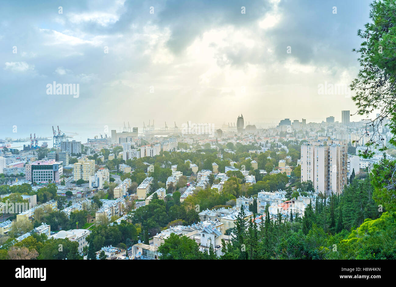 The sun rays among the hard grey clouds over Haifa, Israel Stock Photo ...