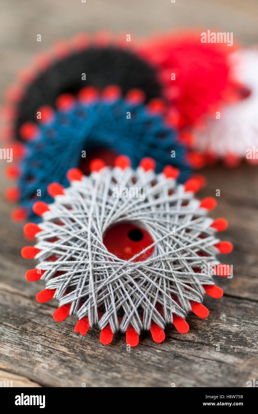 Multi-colored threads on a wooden table Stock Photo