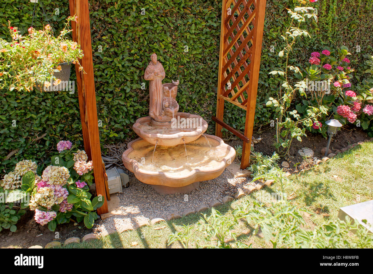 Saint Francis Of Assisi Statue In A Backyard Water Fountain Stock