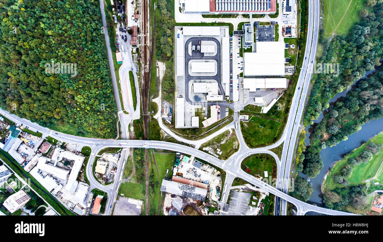 Aerial view of industrial buildings, highway and little town Stock Photo