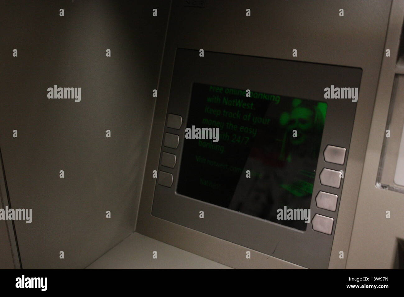 Cash point with green imagery and lettering - hole in the wall Stock Photo