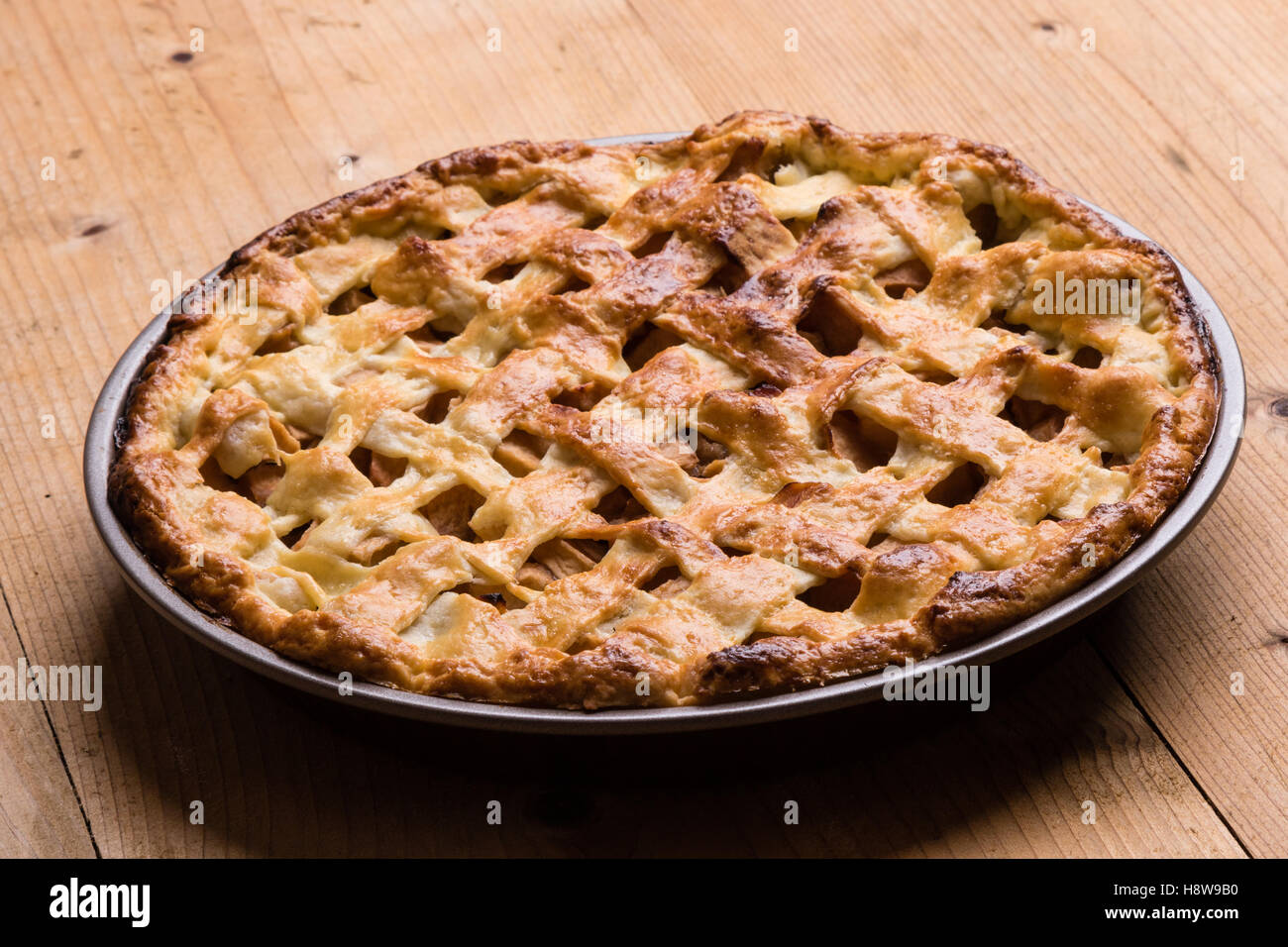 baked fresh apple pie on wooden table Stock Photo