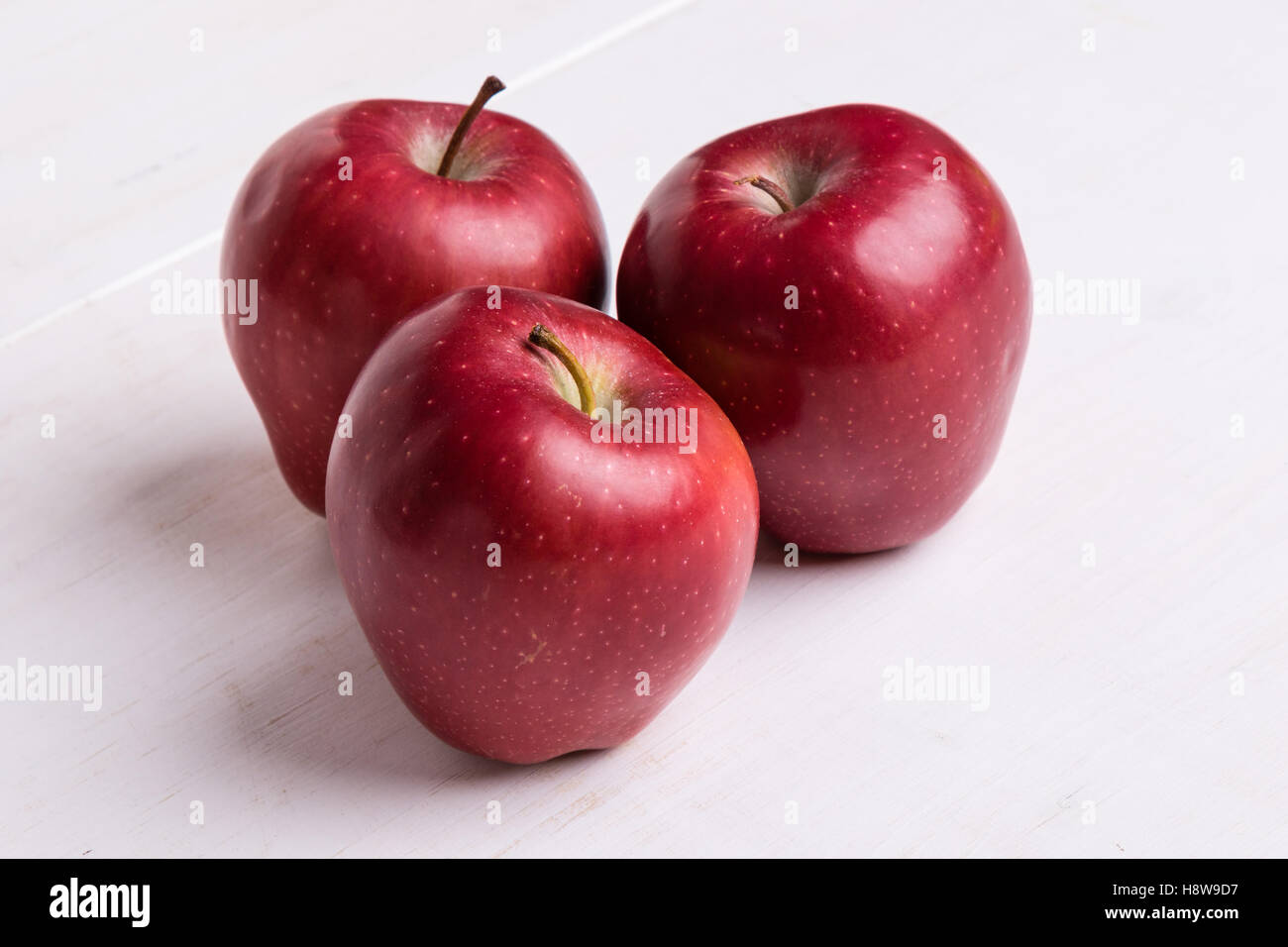 fresh shiny red apple on white table Stock Photo