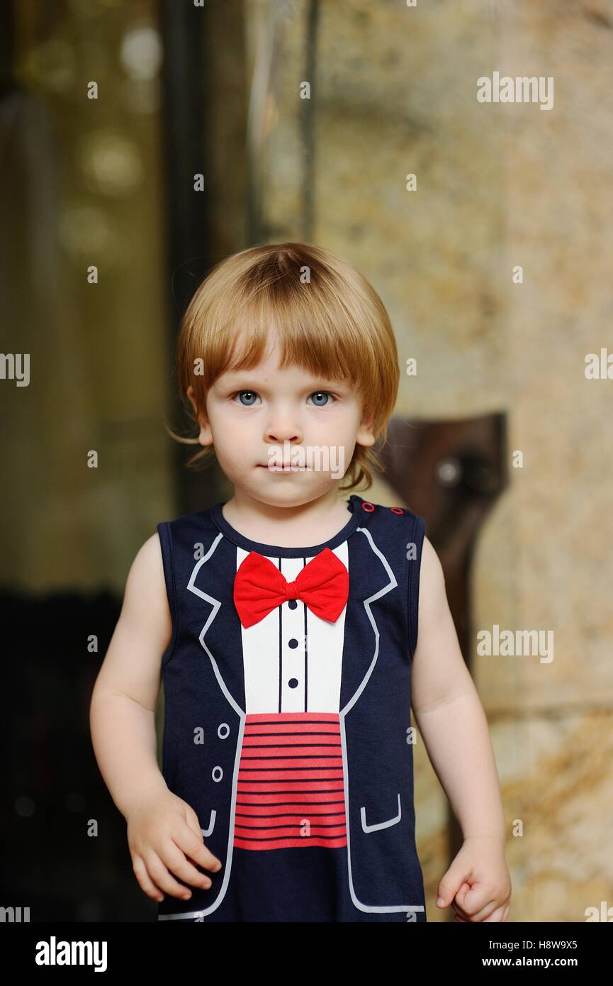 child in a red bow tie on a background of a wall Stock Photo Alamy