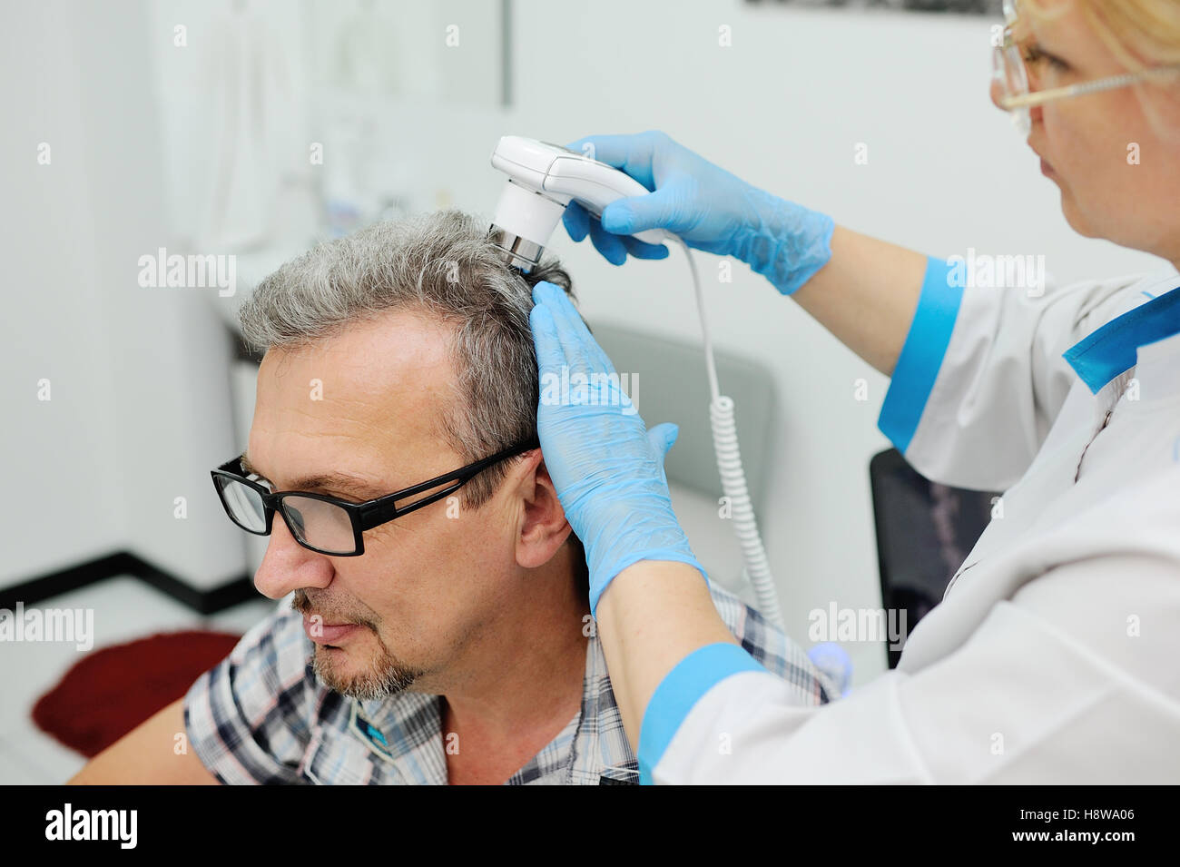 diagnostics hair and scalp. Trihoskopiya. Doctor examine patient male