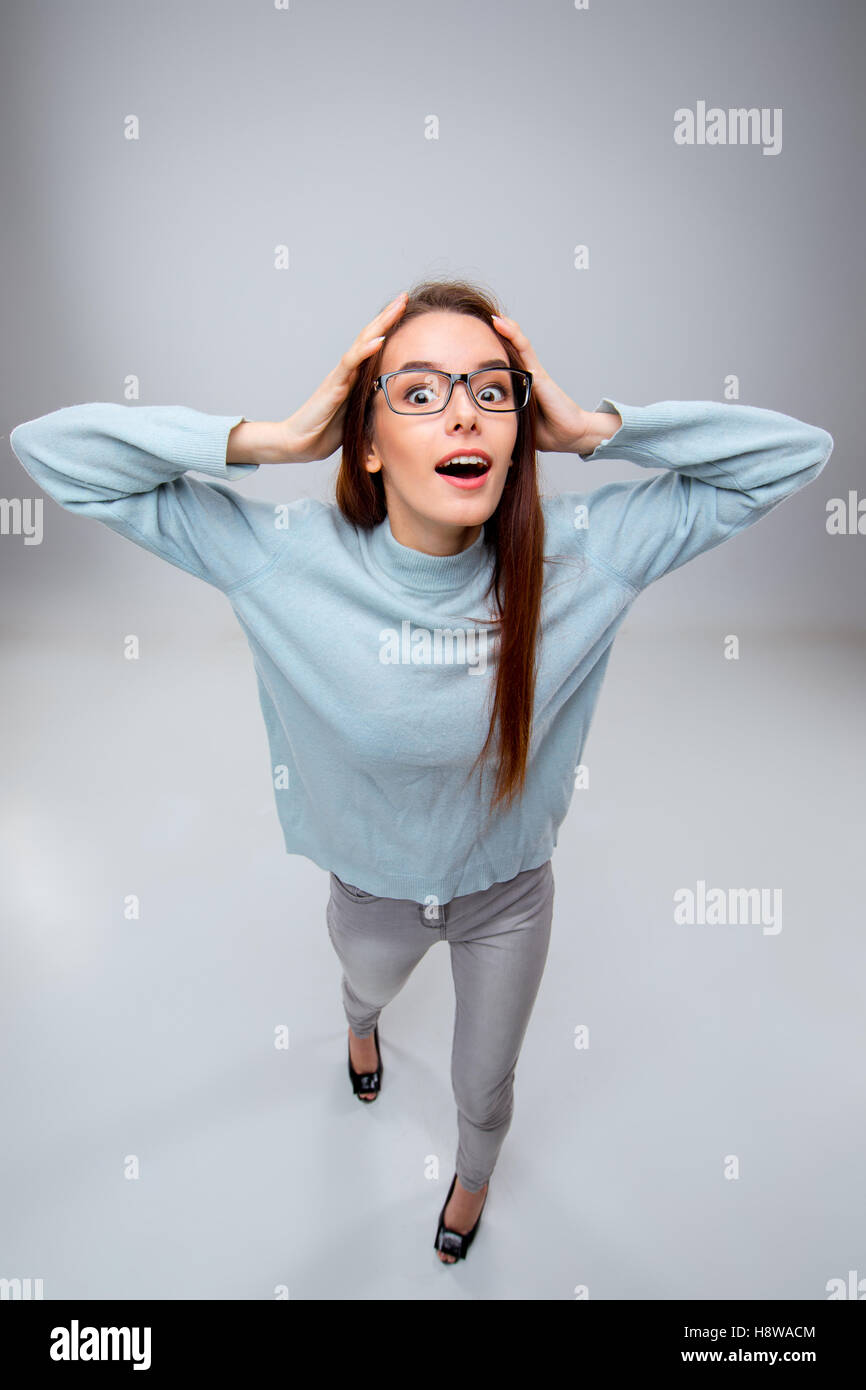 The smiling young business woman on gray background Stock Photo - Alamy