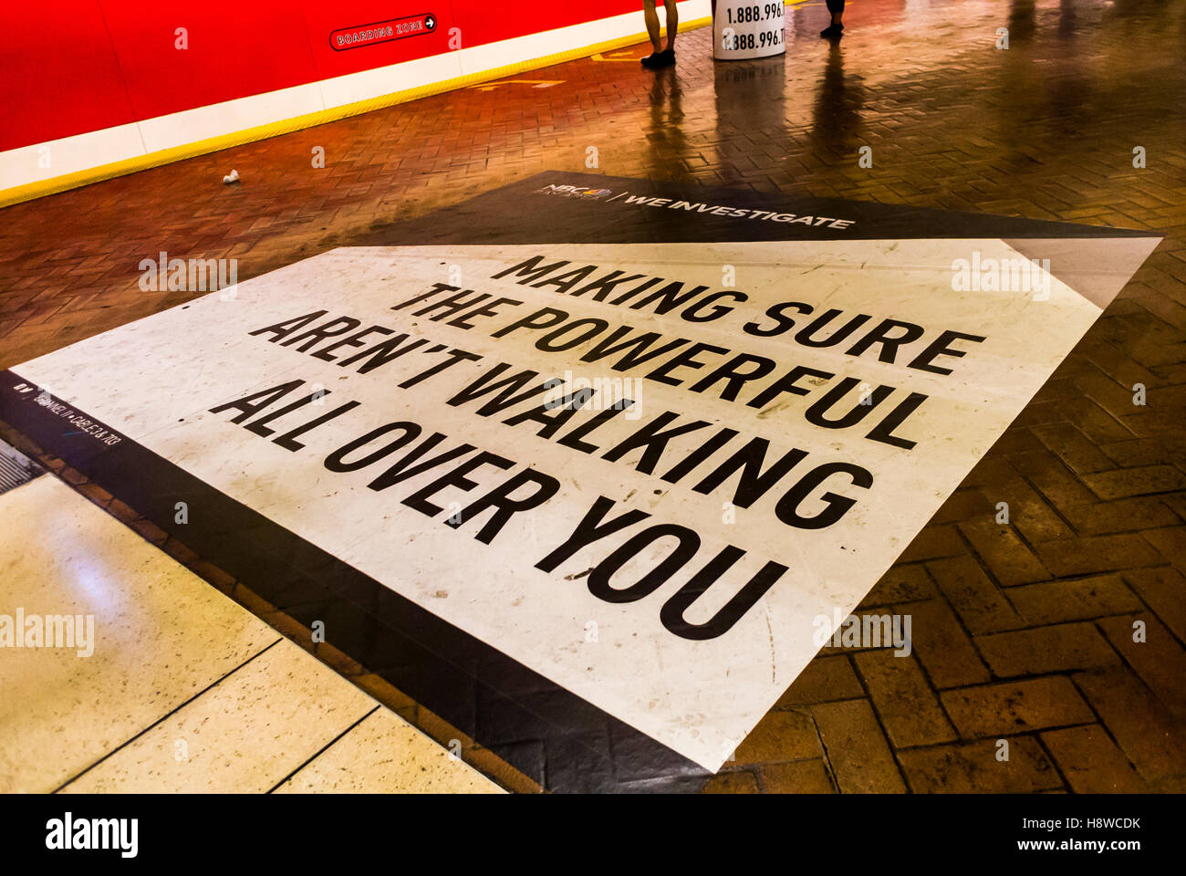 San Francisco, CA, USA, American Advertising poster on Floor, Platform, Inside Metro MUNI Subway Train Station, 'Making Sure the Powerful Aren't Walk' Stock Photo