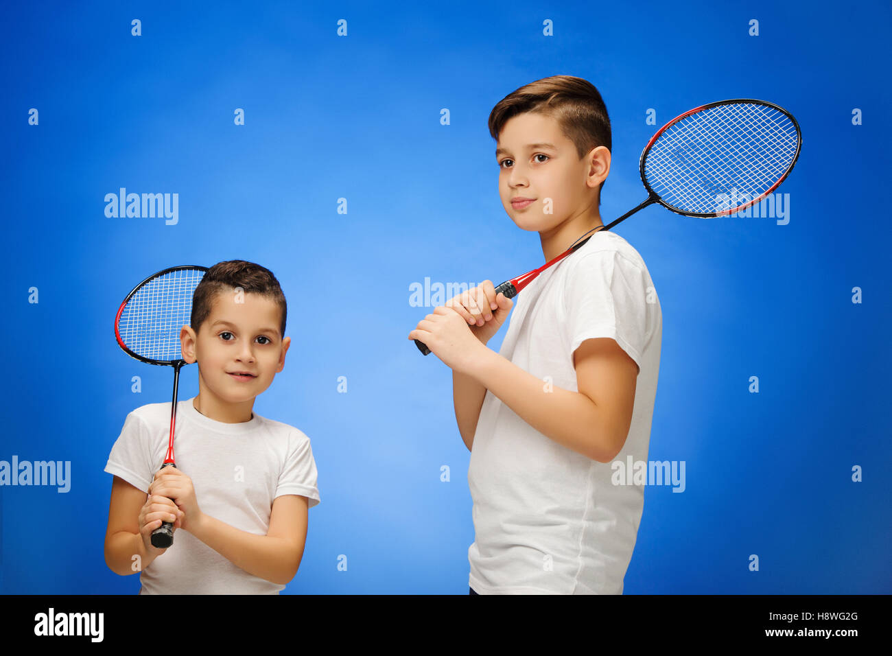 The two boys with badminton rackets outdoors Stock Photo Alamy