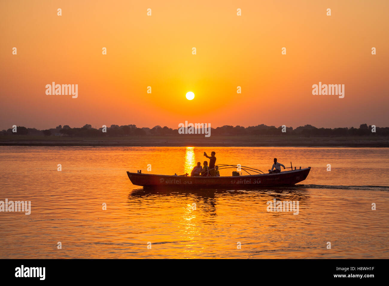 Boat pictured in sunset on the River Ganges, northern India Stock Photo
