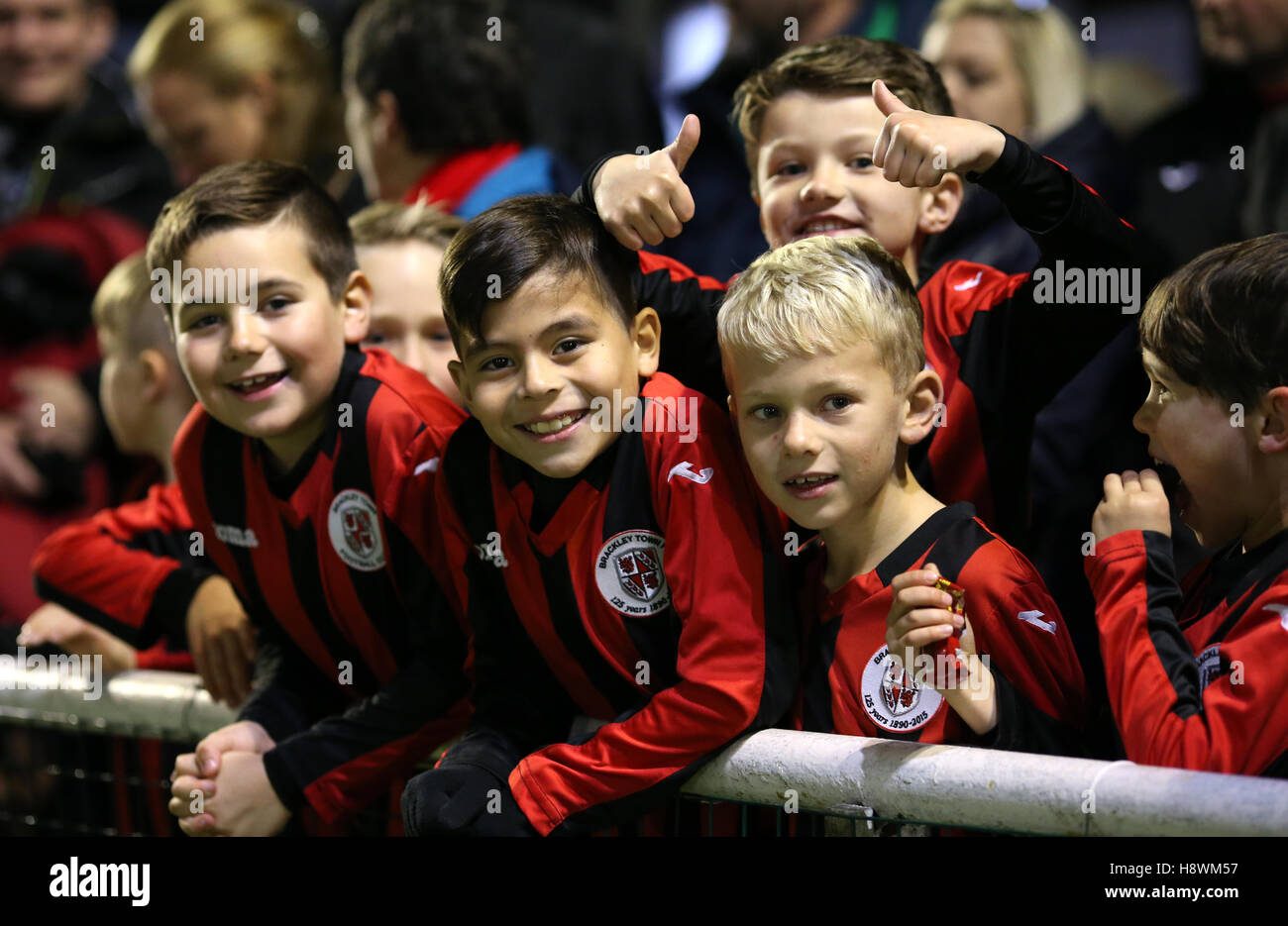 Young Brackley Town fans prior to kick off the FA Cup First Round Replay at St James Park, Brackley. Stock Photo