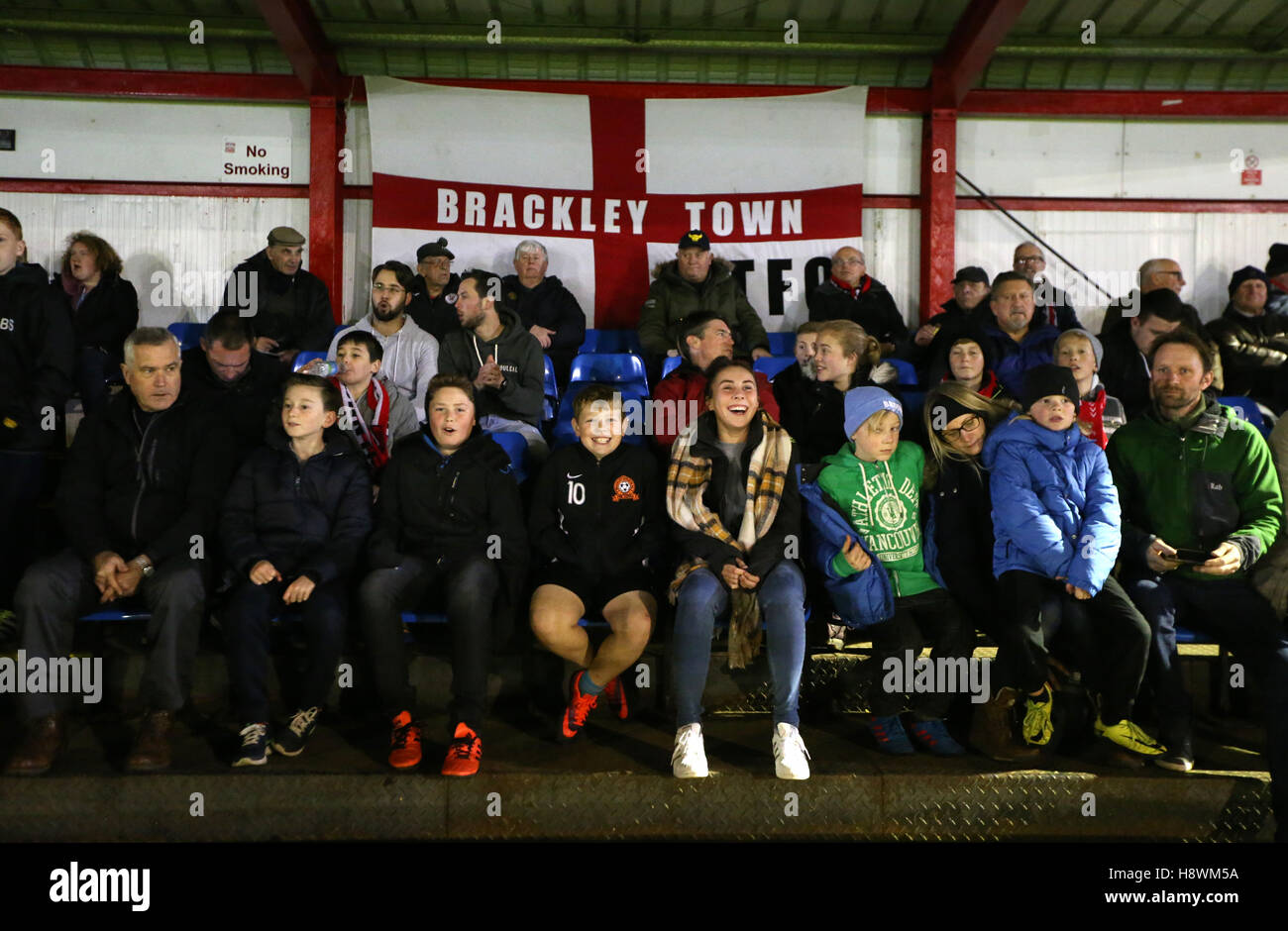 Fans in the stands prior to kick off the FA Cup First Round Replay at St James Park, Brackley. Stock Photo