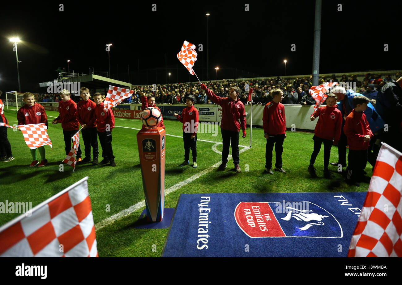 Flag bearerers line up prior to kick off the FA Cup First Round Replay at St James Park, Brackley. Stock Photo