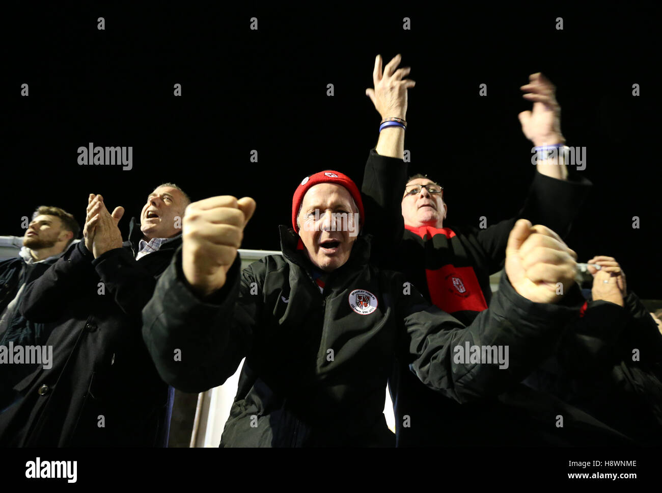 Brackley Town cheer on their team during the FA Cup First Round Replay at St James Park, Brackley. Stock Photo