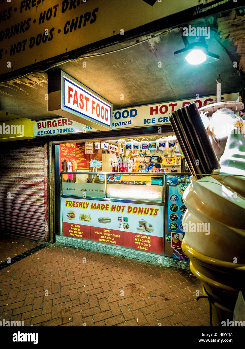 Fast food stall along seafront at night, Blackpool, Lancashire, UK. Stock Photo