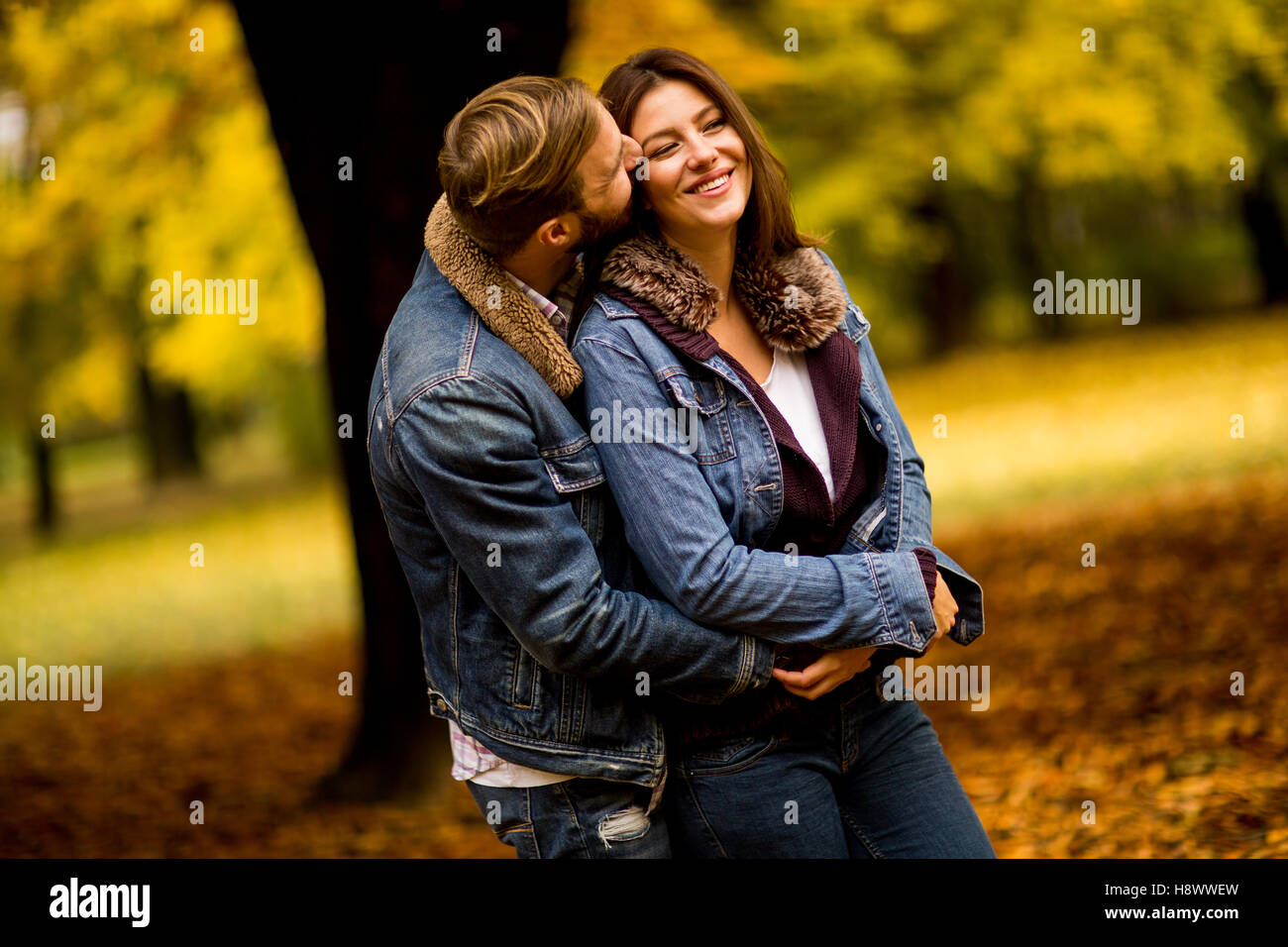 Young couple having fun in the autumn park Stock Photo - Alamy