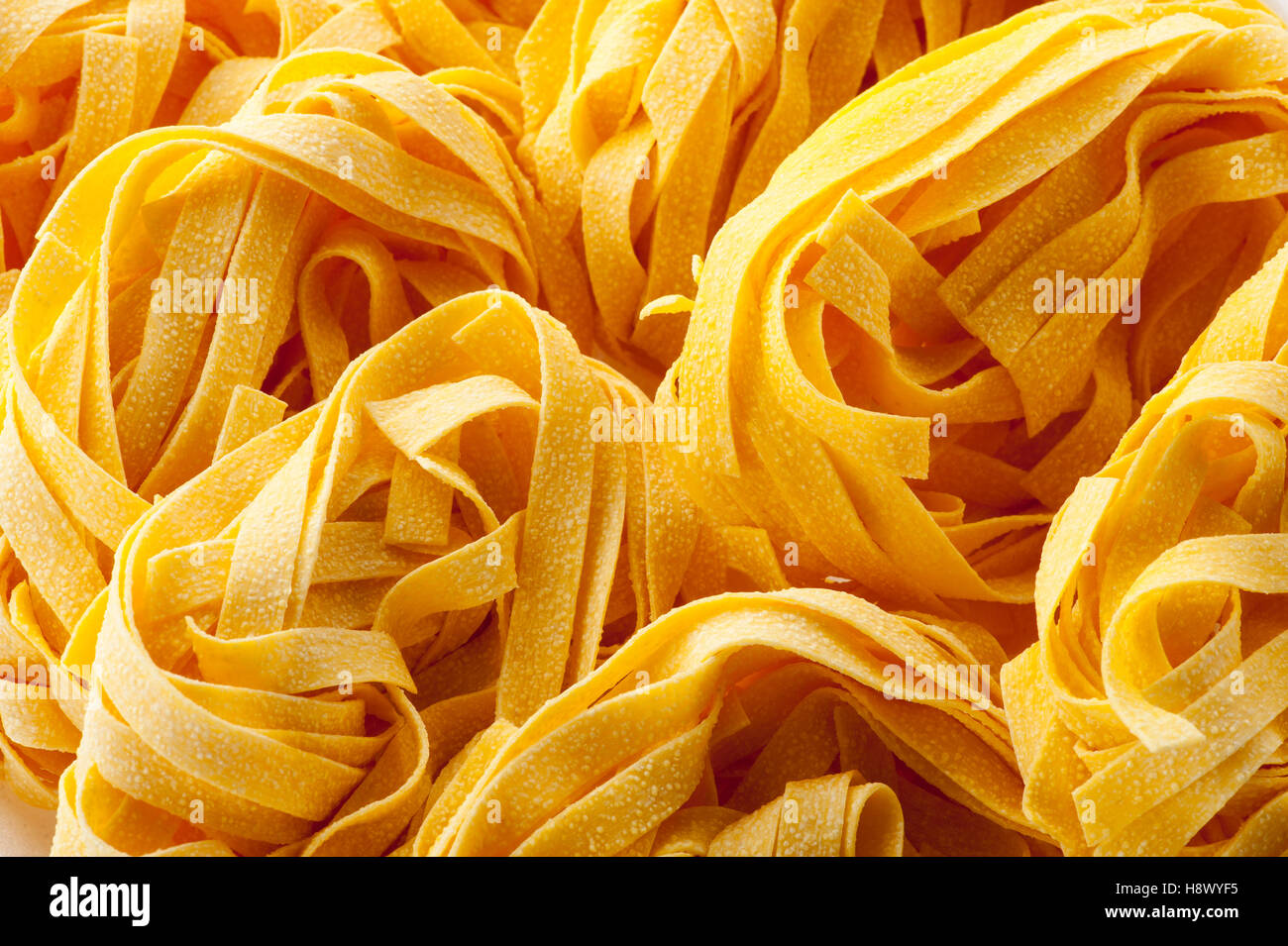 Close up of Italian tagliatelle pasta noodles in a full frame view for food or nutritional concepts Stock Photo
