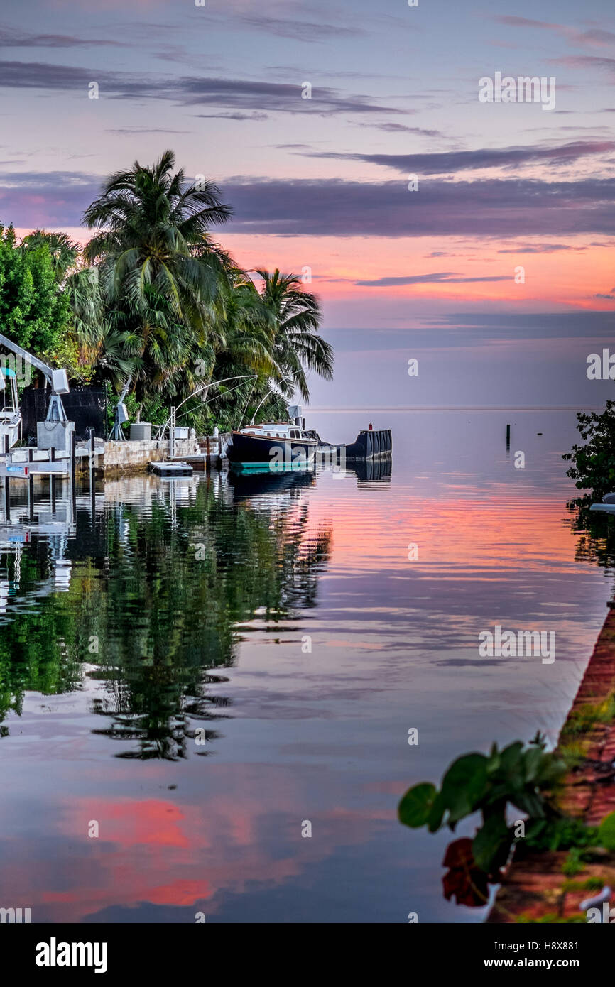 Cudjoe Key Florida during a sunset canal boats orange sky red blue mangroves Stock Photo