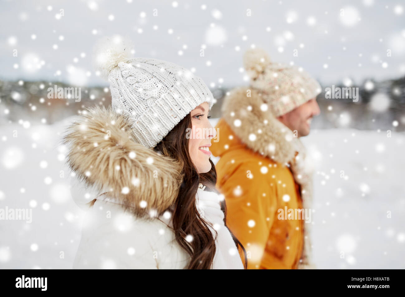happy couple walking over winter background Stock Photo - Alamy