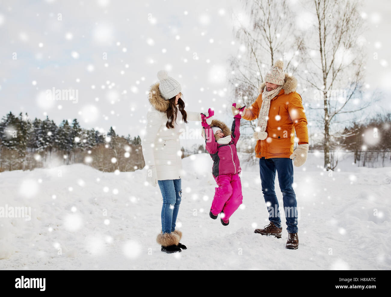 happy family in winter clothes walking outdoors Stock Photo - Alamy
